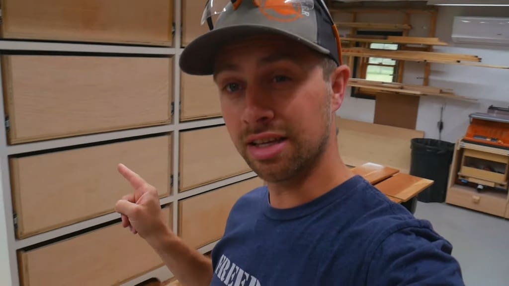 man demonstrating dresser prior to installation of drawer fronts