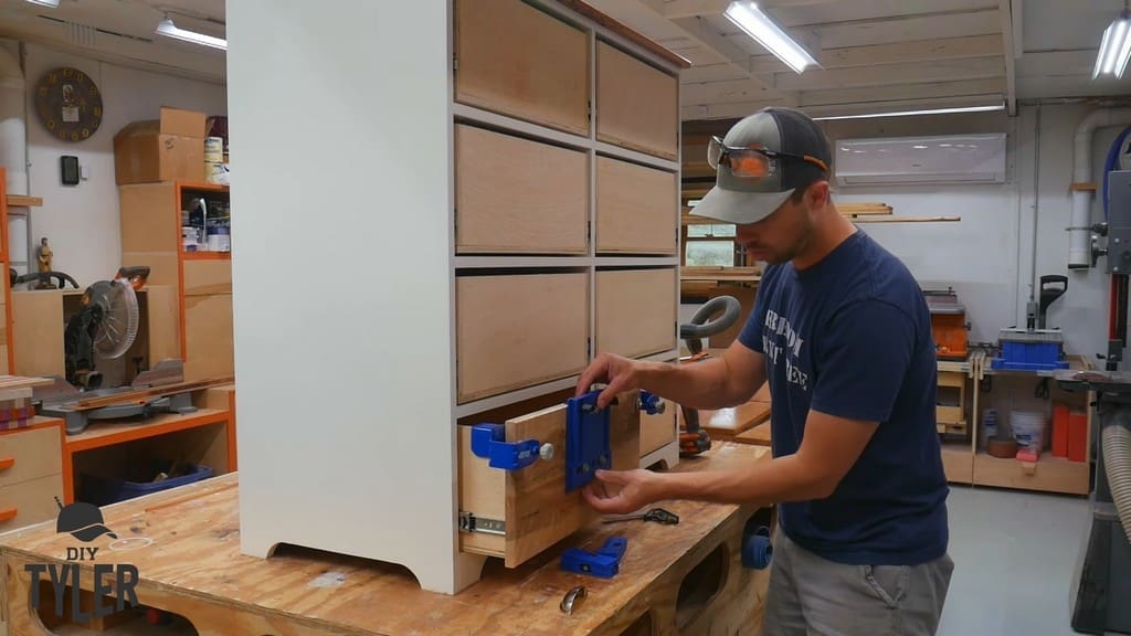man demonstrating Kreg drawer front hole jig