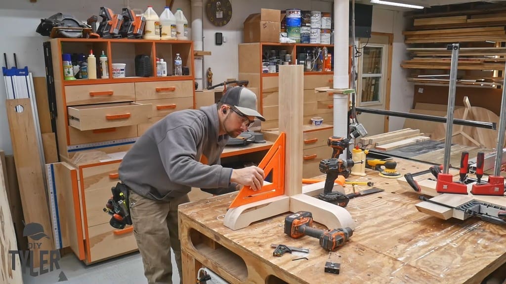 man checking for square for top of pedestal piece