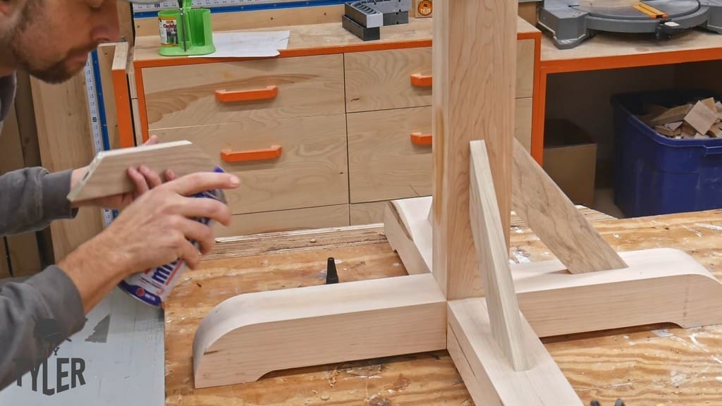man applying quick-activator glue to brace piece