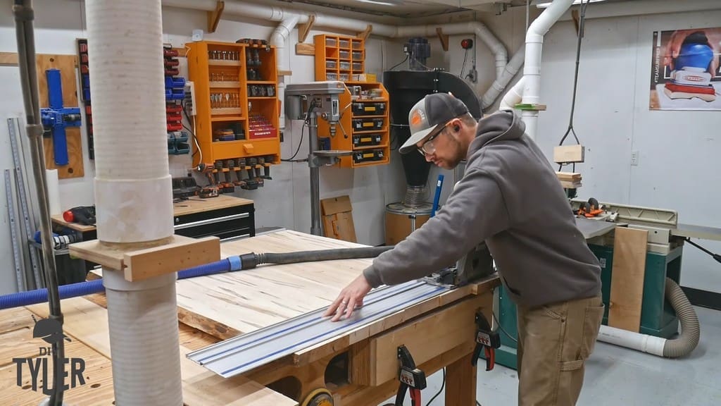 man cutting edges off of slab tabletop with Kreg Track Saw