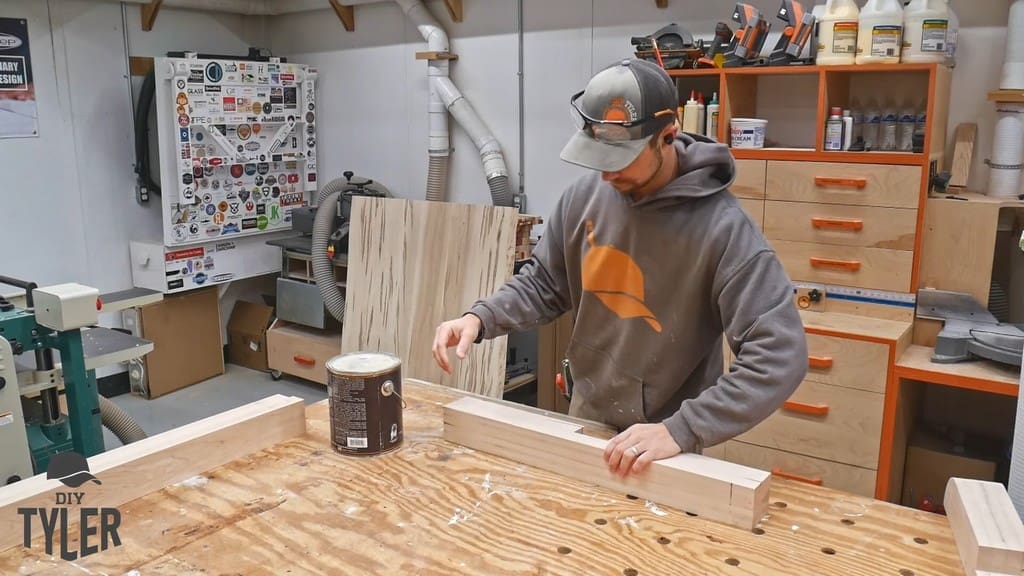 man observing dado joint cut into maple wood piece
